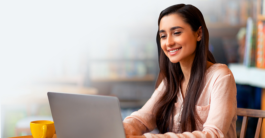 Smiling woman watching her laptop