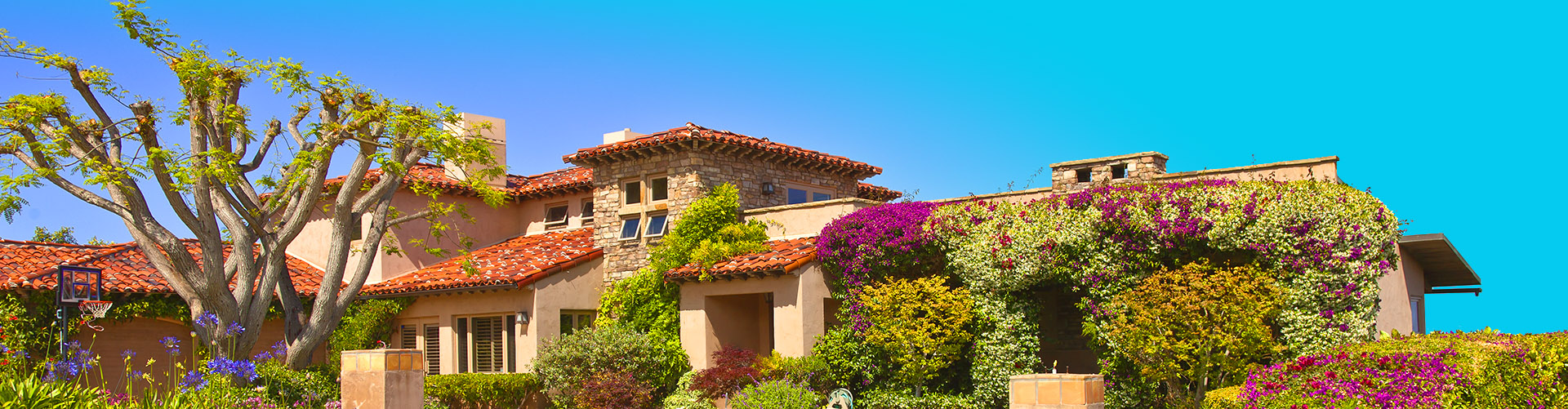 An image of a house with floral landscape.