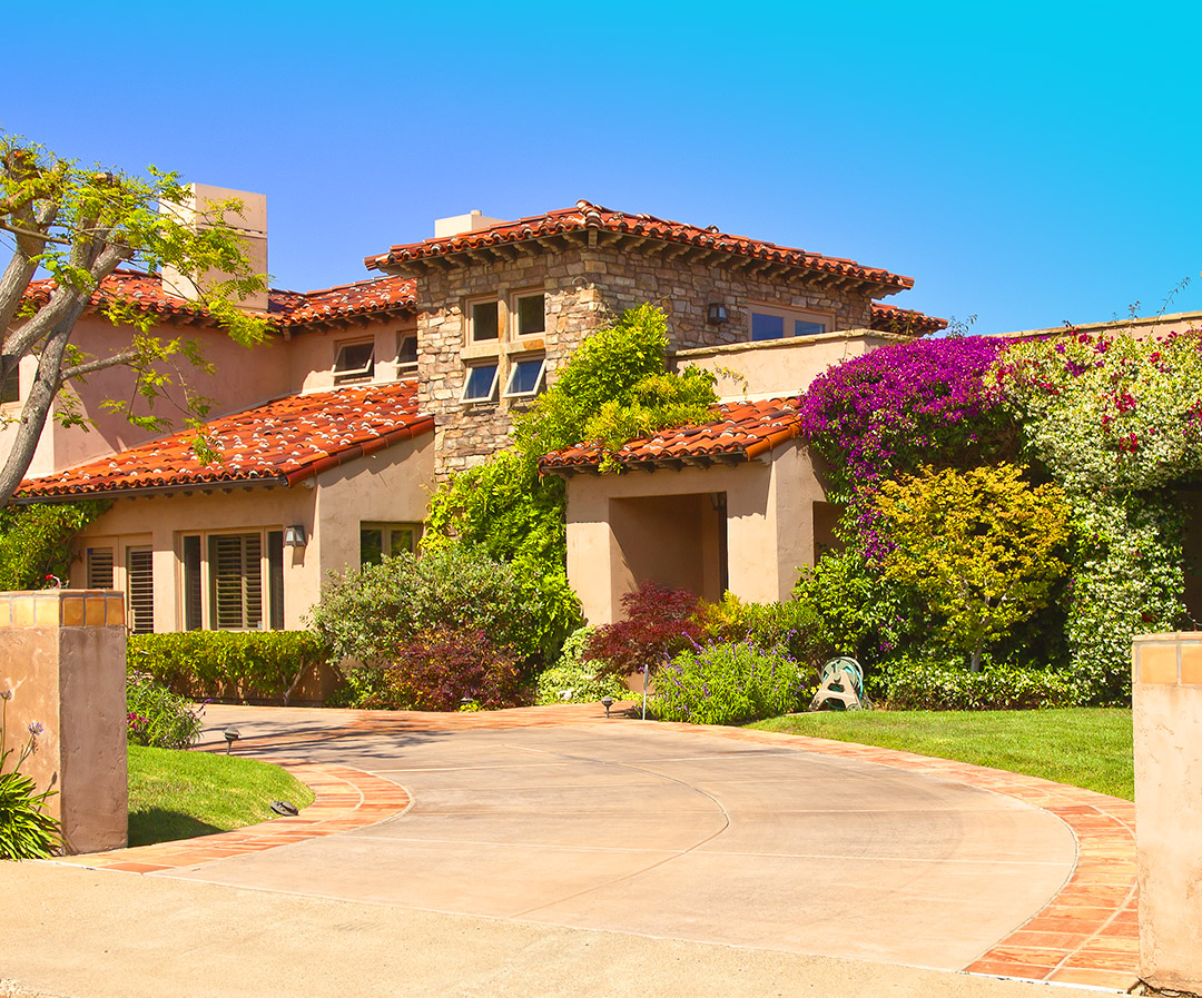 An image of a house with floral landscape.